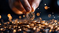 Hand holding golden cryptocurrency coin against dark background with glowing bokeh lights and scattered coins creating magical financial atmosphere.