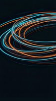 Dynamic swirling light trails in blue and orange creating circular motion patterns on dark background for modern digital design projects.