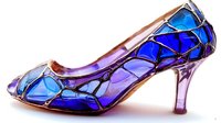 Elegant high heel shoe with stained glass pattern in vibrant blue and purple hues on white background, artistic fashion footwear design isolated for creative projects.