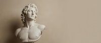 Classical white marble bust sculpture of a young woman with curled hair, displayed against neutral beige background for art, gallery, museum, or interior design projects.