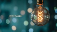 Glowing vintage Edison bulb with spiral filament against blurred bokeh background symbolizing innovation and creative ideas for business concepts.