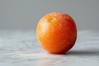 Fresh ripe orange mandarin with textured peel on light gray concrete background, macro food photography with selective focus and copy space.