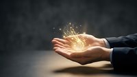 Businessman hands holding glowing golden light energy sphere with sparkling particles, representing innovation, success, power, and business growth potential.