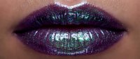 Close-up of lips with metallic purple and green shimmer makeup, featuring bold iridescent glitter finish for cosmetics, beauty, and fashion editorial use.