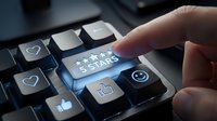 Finger pressing glowing five star rating button on keyboard with social media icons for customer feedback and review system evaluation.