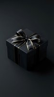 Elegant black gift box with gold-trimmed satin ribbon bow on dark background, luxury present for premium holiday or celebration concept.