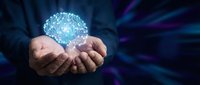 Businessman hands holding glowing digital brain with network connections on dark blue background with light rays for technology and AI concepts.