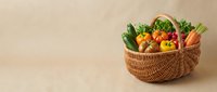 Fresh organic vegetables in wicker basket on neutral background for healthy eating and farm-to-table cooking concepts.