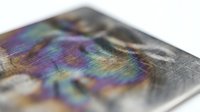 Holographic security foil with rainbow iridescent colors and metallic texture for anti-counterfeiting technology and document protection applications.