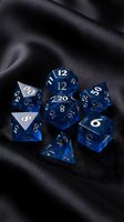 Blue translucent polyhedral dice set on black silk fabric for tabletop gaming and role-playing adventures.