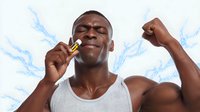 Young African American man in tank top flexing muscles while biting gold medal, expressing victory against blue splash background.