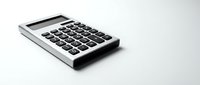 Modern silver calculator with black buttons on white background for business accounting and financial calculations.