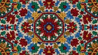 Ornate mandala pattern with vibrant floral motifs in red, blue, gold colors. Traditional decorative design for textiles, wallpaper, meditation spaces.