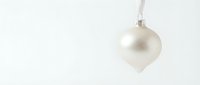 Elegant white Christmas ornament hanging on neutral background for holiday decorations and seasonal marketing materials.