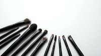 Professional makeup brushes set arranged on white background, tools for beauty and cosmetic application, copy space for text.