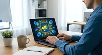 Professional man working on laptop displaying colorful digital marketing icons and social media symbols in modern office workspace for business strategy.