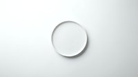 Empty white ceramic plate on light gray background with soft shadow for food photography and kitchen design projects.