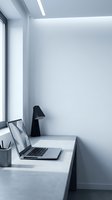 Modern minimalist home office workspace with laptop computer on concrete desk by window with natural light for productivity and remote work.