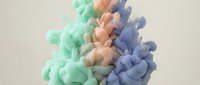 Colorful ink clouds dissolving in water creating abstract fluid patterns in green orange and blue hues for creative design projects.