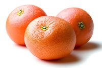 Fresh ripe grapefruits isolated on white background for healthy eating and citrus fruit concepts in cooking and nutrition applications.