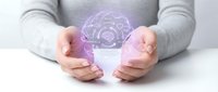 Woman hands protecting glowing purple brain with gears hologram representing artificial intelligence, mental health care and cognitive technology innovation.