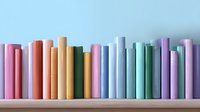 Row of colorful books spines on wooden shelf against light blue wall background, arranged in pastel rainbow colors creating minimalist aesthetic composition.