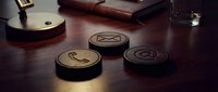 Communication symbols on wooden desk with leather journal and glass of water for business messaging concept.