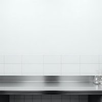 Modern kitchen interior with white subway tile backsplash and stainless steel countertop for contemporary home design and renovation projects.