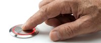 Male hand with light skin tone pressing red emergency button or alarm switch on white background for safety and alert concepts.