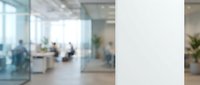 Blurred modern office interior with glass partitions, natural light, and employees working in contemporary workspace environment.