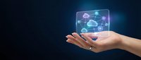 Hand holding holographic cloud computing network with connected devices and data transfer icons on dark blue background for technology presentations.