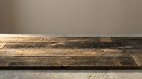 Rustic wooden table surface with weathered planks against neutral wall background for product display and commercial photography projects.