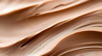 Smooth flowing waves of creamy beige and brown tones create abstract organic curves and layers, presenting soft and gentle movement in minimalist style.