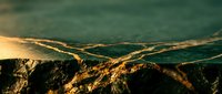 Golden sunset light illuminates dramatic mountain ridges creating layered silhouettes against misty valleys in warm atmospheric landscape photography.
