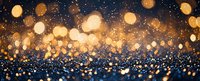 Magical golden bokeh lights on dark blue glittery background create festive holiday atmosphere with sparkling defocused circles and shimmering effect.