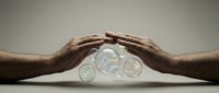 Hands protecting transparent coins on neutral surface, symbolizing financial security, savings protection, and wealth management for business concepts.