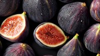 Fresh ripe purple figs with bright red flesh and water drops on dark background, whole and cut in half, macro food photography for restaurant menu.