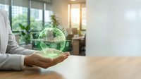 Businessman holding glowing green earth globe with recycling symbol in modern office, representing environmental sustainability and corporate responsibility.