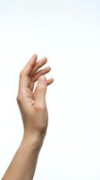 Human hand reaching upward with slightly curved fingers, isolated on white background, showing natural skin texture and veins.