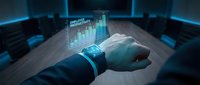 Businessman hand with smartwatch displaying holographic financial charts and data analytics in futuristic blue technology environment for business presentations.