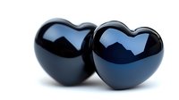 Two glossy black heart shapes on white background, romantic symbol with reflective surface and smooth curves, isolated for design projects and creative use.