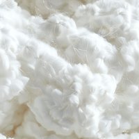 Soft white cotton fiber macro background showing natural raw cotton texture and delicate threads. Suitable for textile and fabric industry visuals.