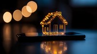 Glowing house-shaped string lights on smartphone creating cozy atmosphere with bokeh background and reflection on dark surface. Perfect for holiday season concepts.