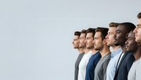 Diverse group of professional men standing in line profile view representing teamwork unity and corporate collaboration in modern workplace.