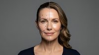 Middle-aged Caucasian woman showing aging process with half face displaying wrinkles and age spots while other half appears youthful and smooth.
