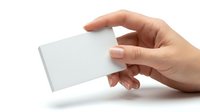 Hand holding blank white business card mockup on clean background for branding and corporate identity design projects.