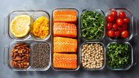 Healthy meal prep containers with salmon, vegetables, legumes and grains arranged for balanced nutrition and convenient weekly planning.
