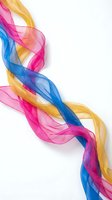 Vibrant flowing silk ribbons in pink blue yellow creating dynamic wave motion on white background for creative design projects.