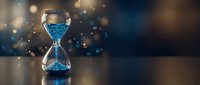 Digital hourglass with binary code sand flowing through glass bulbs against bokeh background representing time management and data processing concepts.