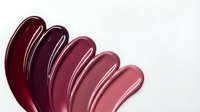 Glossy burgundy and pink lipstick swatches in gradient shades for cosmetic beauty makeup collection isolated on white background.